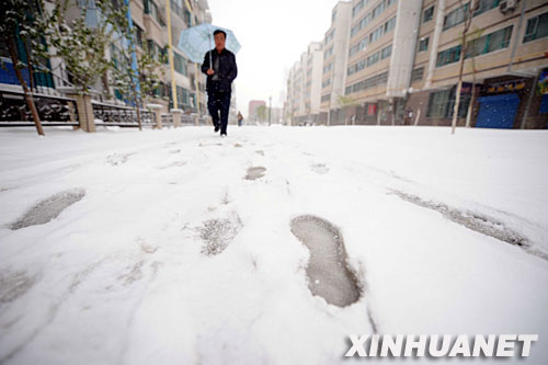 4月18日,一名市民在乌鲁木齐一小区内回家的路上。