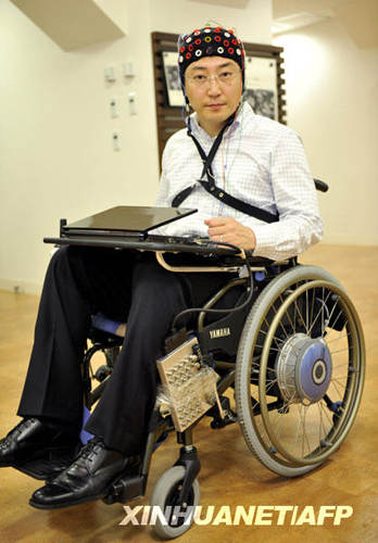 6月29日,在日本东京,一名研究人员展示安装了脑电波控制系统的轮椅样车。日本丰田汽车公司日前宣布,该公司成功研发出了一种可以用脑电波控制轮椅的新技术。使用这种轮椅的残疾人无需动用肌肉力量或是发出声音指令,即可让轮椅载着自己行动自如。新华社/法新