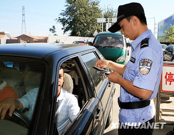 9月15日,民警在白庙综合检查站对进京车辆进行安全检查。新华社发(谭志勇 摄)
