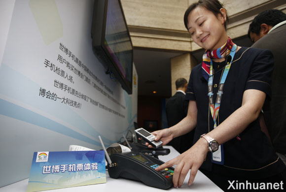 10月13日,一位工作人员正在演示如何将票务信息下载到手机SIM卡中。新华社记者 裴鑫 摄