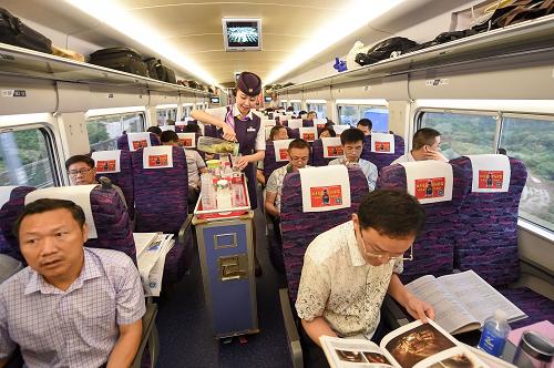 6月28日,从合肥南开往福州的g2621次列车上,乘务员在为旅客服务.