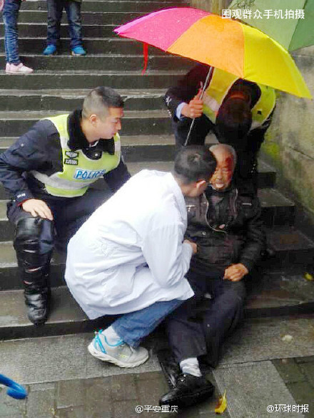 重庆老人摔倒街头 协警为其撑伞避雨当 人肉靠